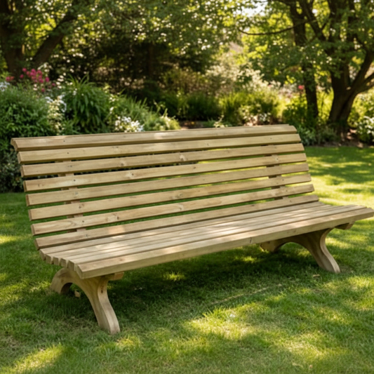Large heavy-duty wooden garden bench with wide slatted back and curved cross-leg supports on a lush garden lawn